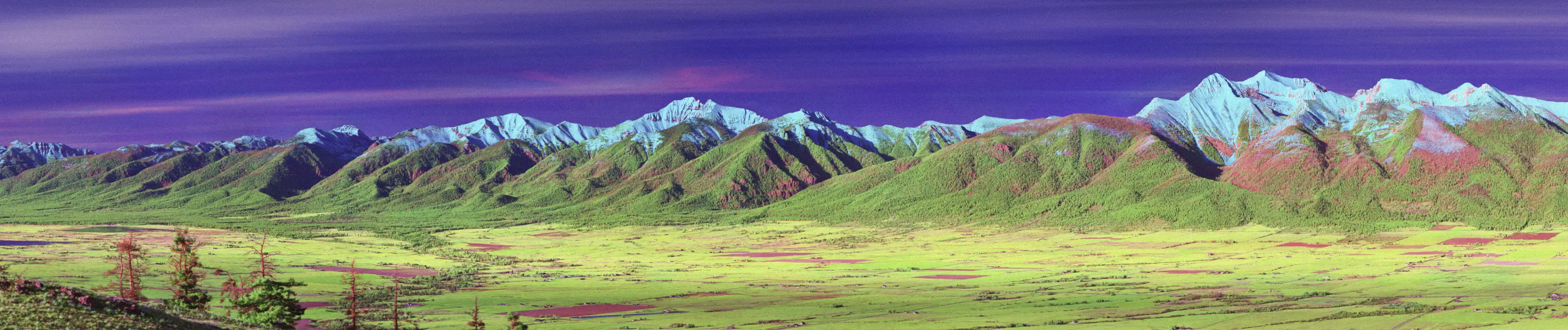 Colour translaterated shortwave infrared (SWIR) photograph of Mission Mountains Montana